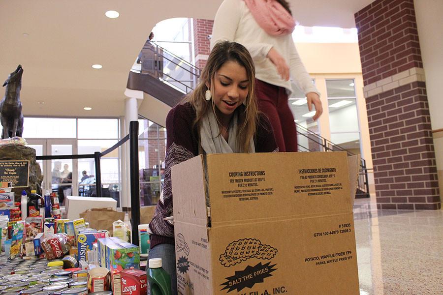 Katherine Barr loads some of the canned food items collected during the drive.  All of the donations help families in need through Frisco Family Service.  