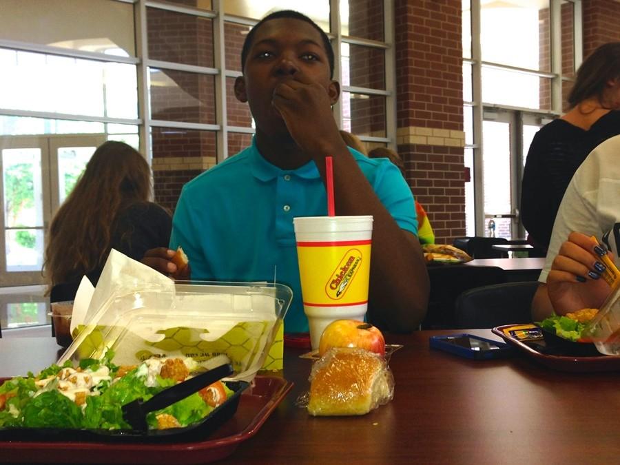 Tyler Horne enjoys a break from the cafeteria food with Chicken Express. A restaurant frequented by students. 