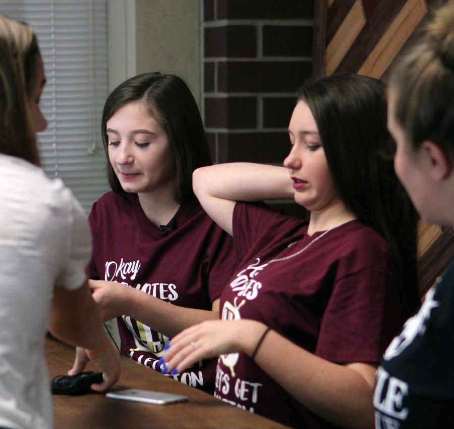 Going over their show script, junior Julia McComas and sophomore Katherine Derryberry prepare for Coyote Nation TV Live on Oct. 3. This was the first daily show in over a year, as they were monthly during the previous year.