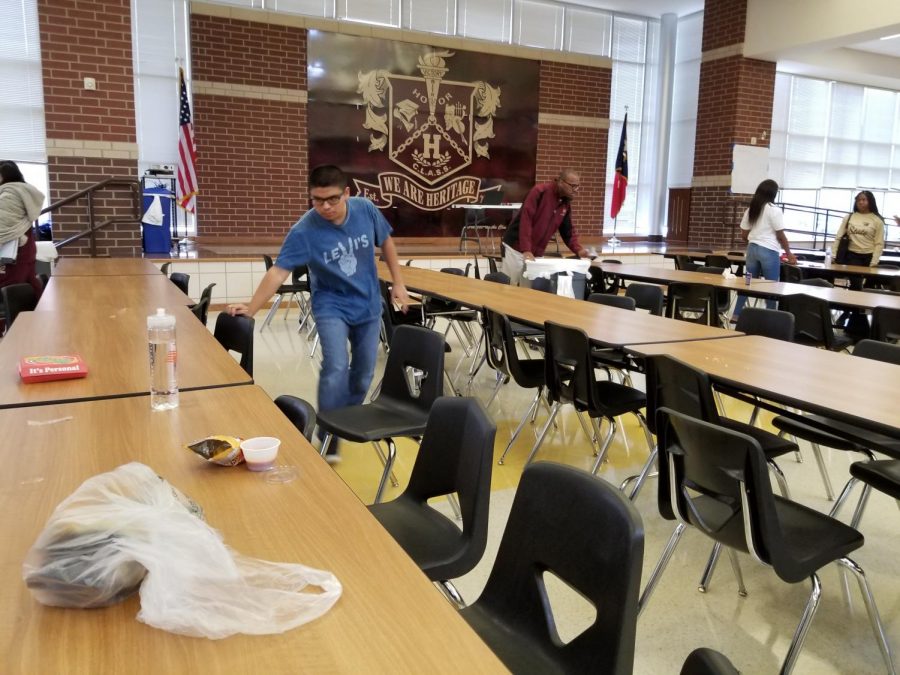 Trash+is+left+behind+after+the+lunches.+Some+students%2C+like+Brian+Rios+%28left%29%2C+have+stepped+up+to+perform+a+small+service+for+the+custodians+by+cleaning+the+load+of+trash+laying+around.