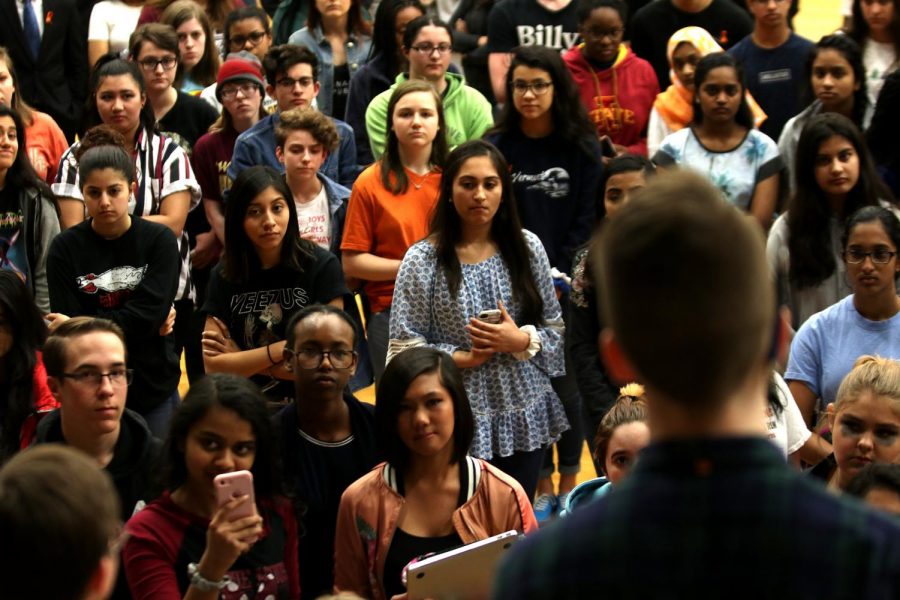 Students look on as senior Ryan Short speaks at the student Walkout Friday. 
