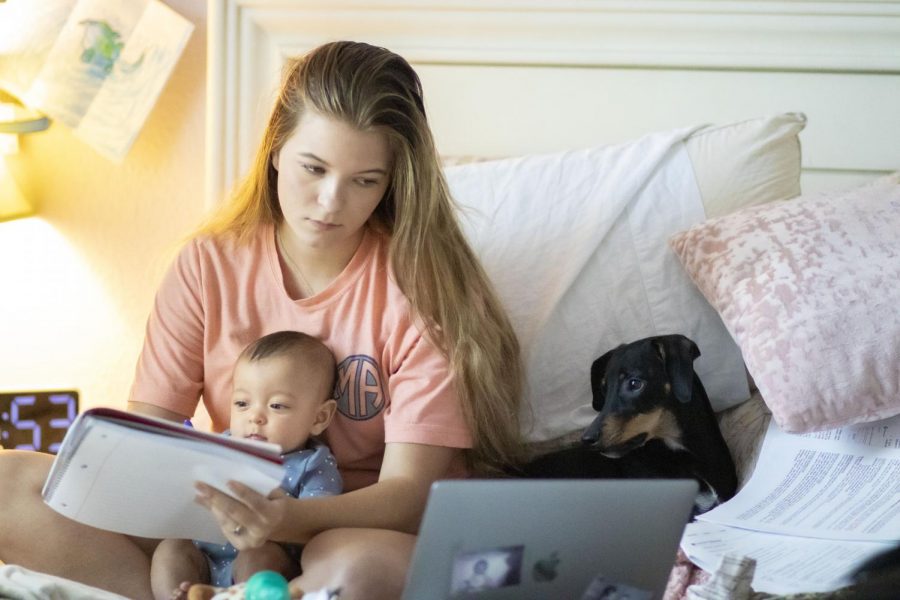 Ainslee Smith works on her college course while trying to entertain her son, Everett. Ainslee gave birth to him back in April 2019 and has been juggling school and being a new mother since. 