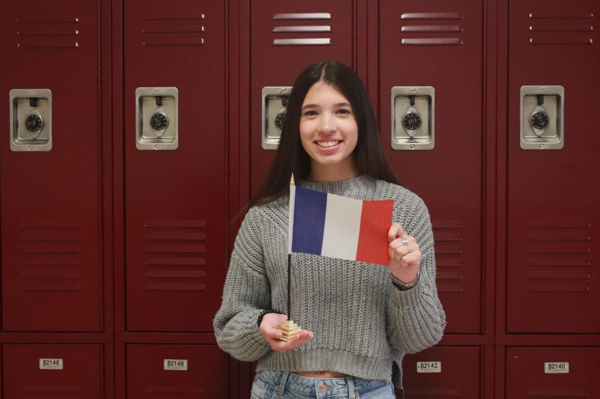 Junior Anna Dombek holds up the flag of her home country. (Photo by Madhurima Thamma)